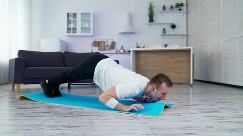Man Doing Pushups and Planks on Yoga Mat