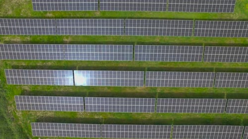 Solar Panels In The Green Field, Renewable Energy Concept. - aerial