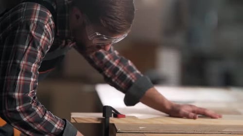 Closeup portrait of carpenter clamping carpentry board