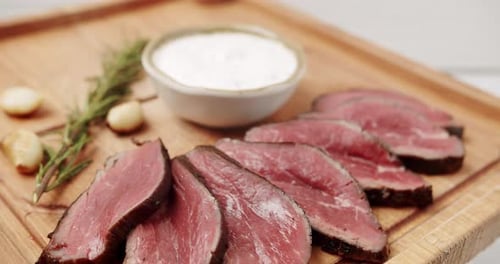 Sliced Beef Tenderloin with Garlic and Rosemary Garnish