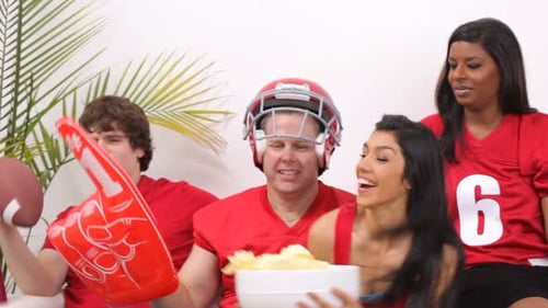 Friends Cheerfully Watch Football at Home on TV