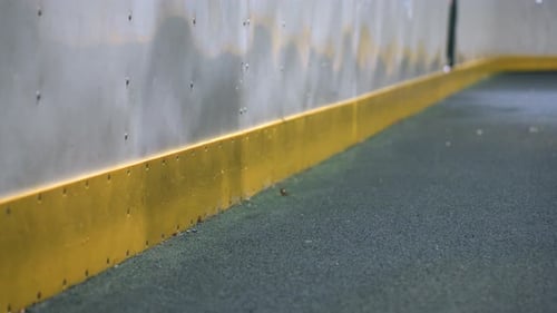 Reflection on Wall with Soccer Ball Impact Under Bright Lighting
