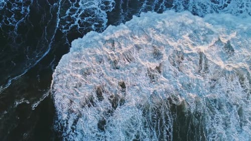 Aerial Top View on Big Waves at Sunset