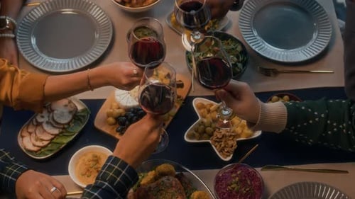 Festive Friends Toasting Wine at Dinner Table