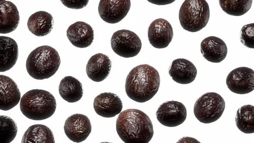 Falling Passion Fruits Against White Background
