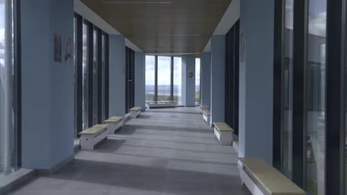 Corridor with Glass Walls and Benches Inside Skyway Bridge