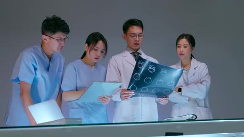 Medical Team Reviews X-Ray in Hospital Setting