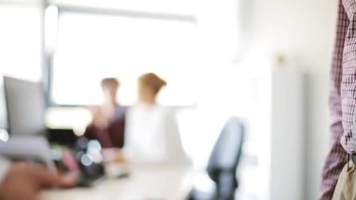 Business Handshake Agreement in Modern Office Setting