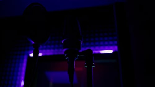 professional recording studio song recording equipment microphone close-up bottom view neon light