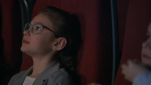 Focused Girl Watching Cinema Movie. Closeup Shot Of Kids Watching Movie. Young Spectators Enjoy F...