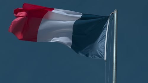 French Flag Waving Against Blue Sky
