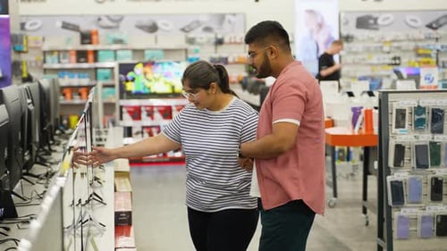 Young Couple Buying New Tv Television in Home Appliance Store