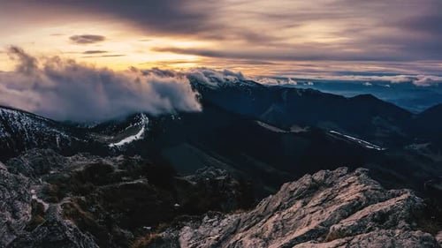 Mountain Range at Sunrise with Clouds and Snow