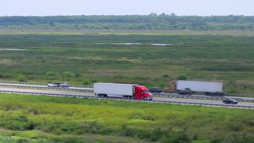 Semi Truck Driving on Interstate Freeway Hauling Cargo Delivering Loads Concept