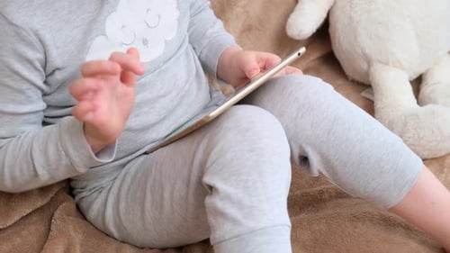 Child Using Tablet Device Indoors at Home