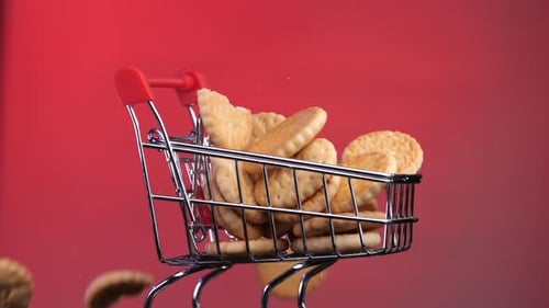 Shopping Grocery Cart Trolley is Completely Filled with Cookies and Rotates