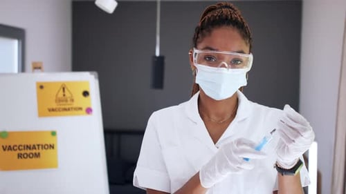 Healthcare Worker Prepares Covid-19 Vaccine Shot Indoors