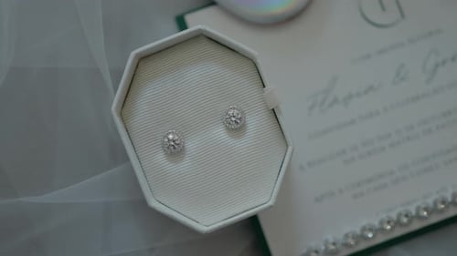 Diamond Earrings and Wedding Invitation Close Up