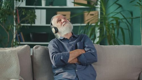 Senior Man Listening to Music on Couch