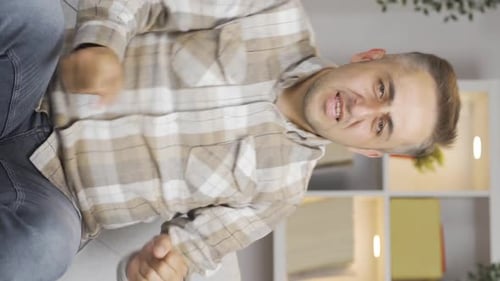 Vertical video of Happy man dancing to the camera.