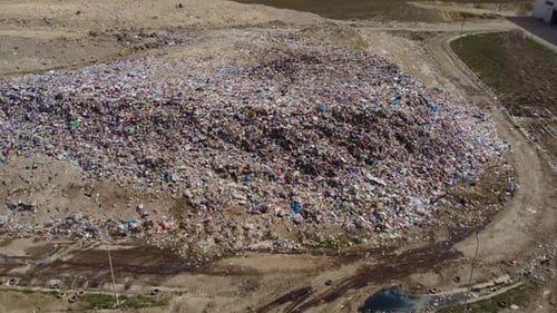 Aerial view of garbage mountain and road near