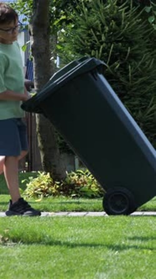 Vertical Video Boy Rolls Out Trash Can Waste Collector Garbage Removal