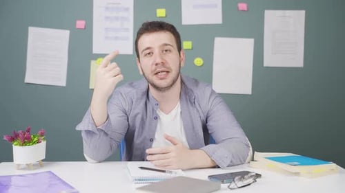 Young Adult Explaining a Concept at Desk