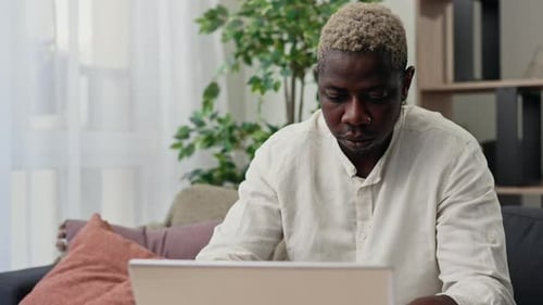 Close View of the African American Man Working From Home Studying Online During Pandemic