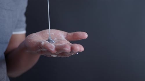 Hand with Soap and Gray Fluid Close Up