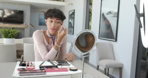 Young Adult Applying Makeup at Home