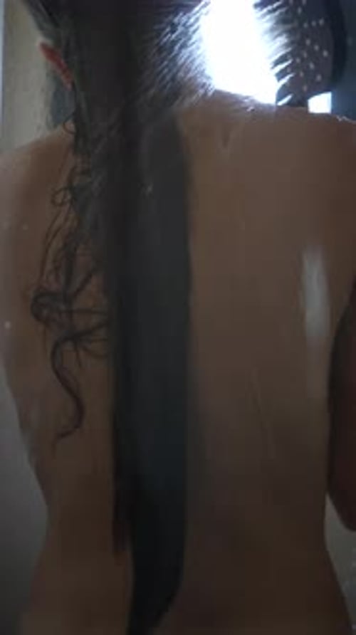 Woman Washing Long, Dark Hair in Shower