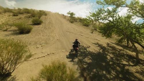 Motorbiker Rides Vehicle Up Bushy Hill Fpv Drone