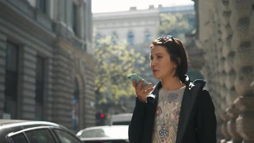 Woman Using Voice Command on City Street