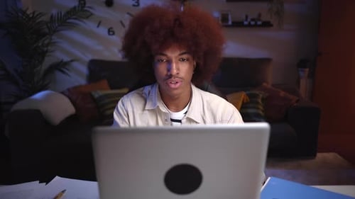 Young Adult Working on Laptop at Night