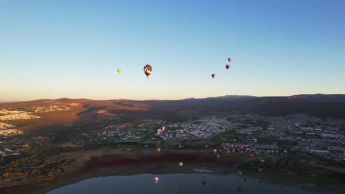 Hot Air Balloons Over Tranquil Town at Sunrise