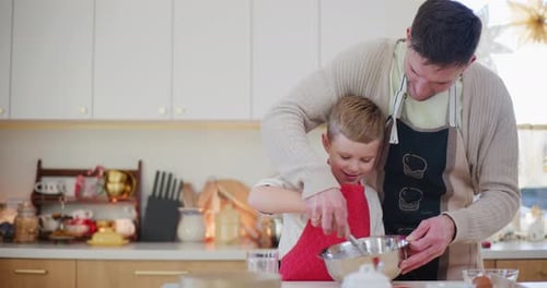 Man and Child Baking Together in Home Kitchen