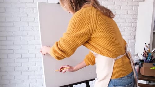 Woman Artist Sketching on Canvas in Art Studio