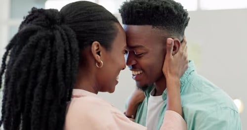 Loving Couple Smiling with Foreheads Touching Indoors