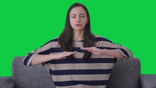 Indian girl doing breathe in breathe out exercise Green screen