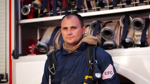 Firefighter Standing in Front of Firetruck
