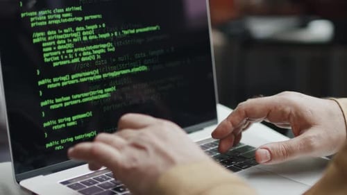 IT Specialist Writing Codes on Computer