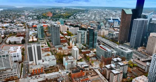 Beautiful cityscape of Seattle, Washington, US. Drone descending over the vast urban landscape.