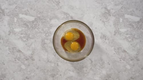 Time Lapse Mixing Ingredients in a Glass Mixing Bowl to Prepare Coconut Banana Pancakes