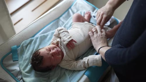 Newborn Baby Cries During Diaper Change on Changing Table