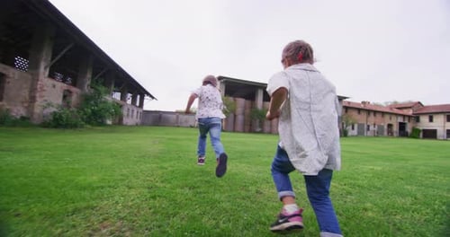 Authentic shot of two cute little girls sisters carefree having fun on a countryside background in