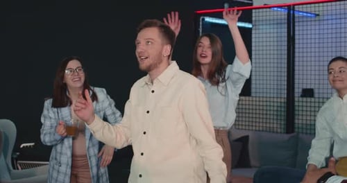 Young Happy Male Start Up Office Manager Celebrating Work Success with Diverse Colleagues Dancing