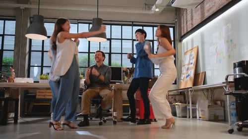 Business man and woman dance together in office after finish work or project and success in project