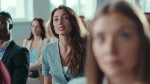 Business Audience Listening Attentively at Conference Presentation