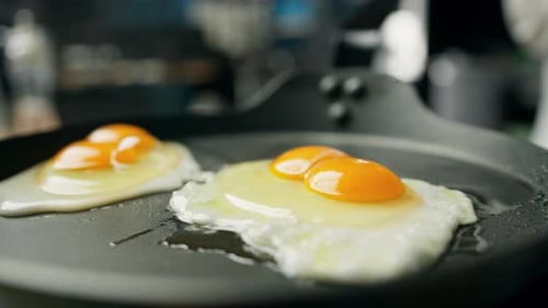 Fried Eggs Cooking in a Pan Close Up