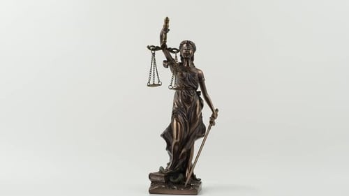 Bronze statue of Lady Justice rotates on a white background.